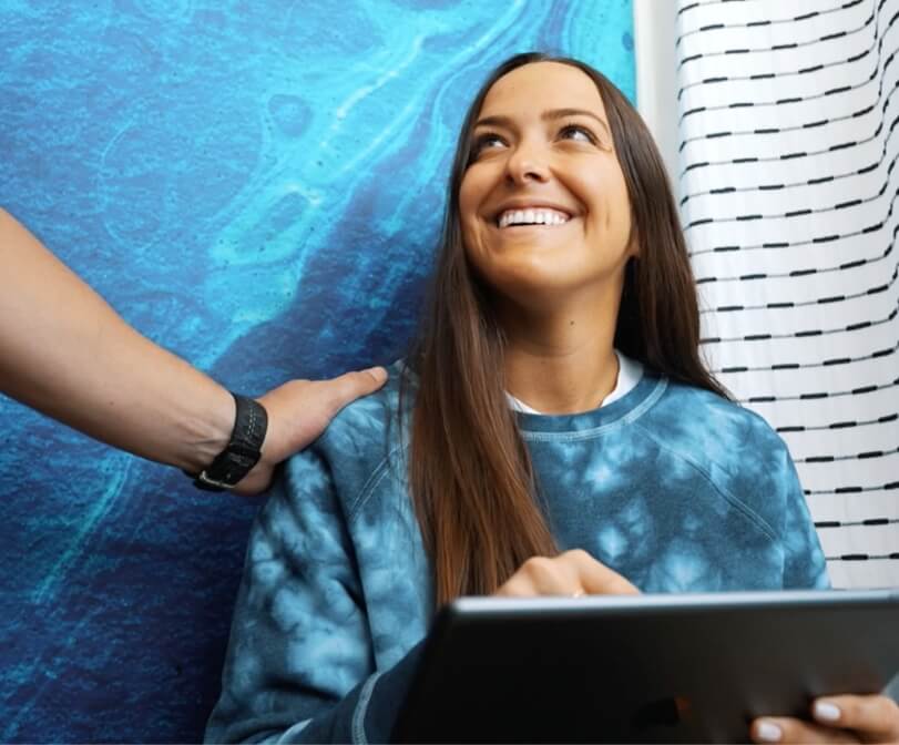 woman smiling while visiting Flossy Smiles, dentist in Miami, FL